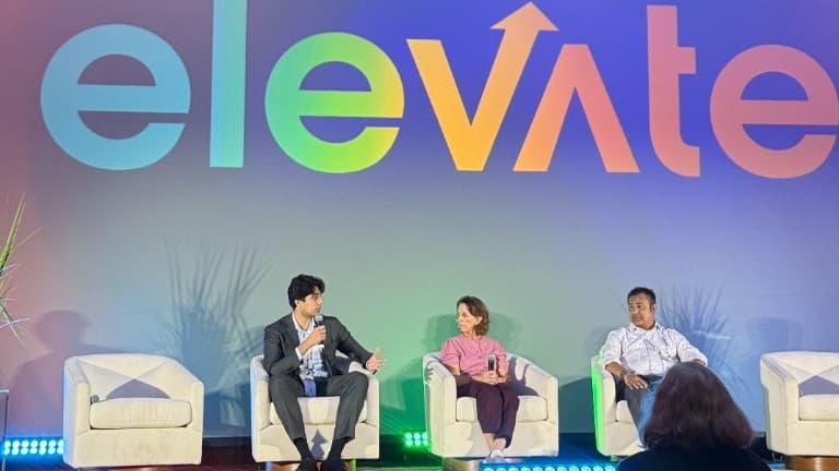 Akhil Sachdev speaking on a panel in front of the Elevate logo at the Hotel del Coronado