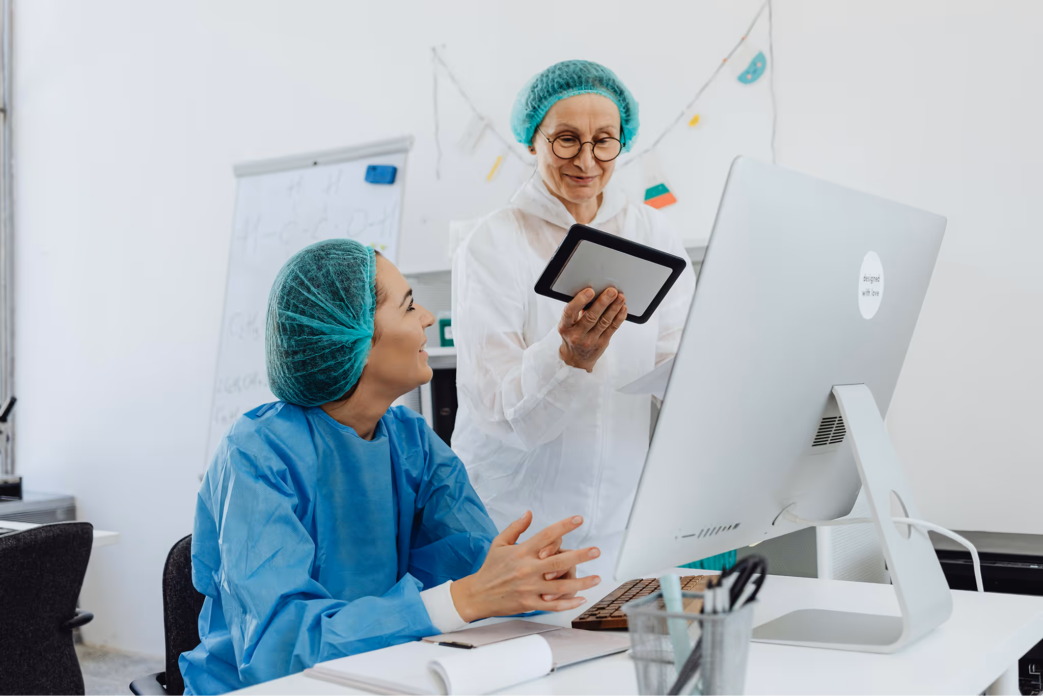 Clinicians reviewing information on a tablet and computer